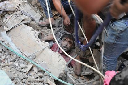 Palestinians rescue a survivor of Israeli bombardment of the Gaza Strip in Nusseirat refugee camp on Tuesday.