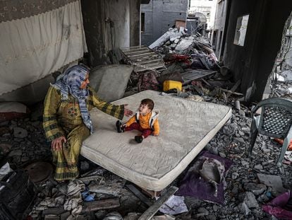 A Palestinian woman and her son in a bombed-out house in Gaza.