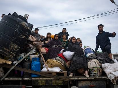 Palestinians arrive in the southern Gaza town of Rafah after fleeing an Israeli ground and air offensive in the nearby city of Khan Younis on Friday, Jan. 26, 2024.