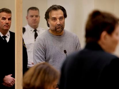 Brian Walshe, center, listens during his arraignment Wednesday, Jan. 18, 2023, at Quincy District Court, in Quincy, Mass., on a charge of murdering his wife Ana Walshe.