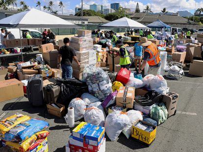 Hawaii stevedores and other volunteers prepare donations for the victims of the Maui wildfires at Pier 1, where they will ship them to Maui next week, in Honolulu, Hawaii, on August 12, 2023.