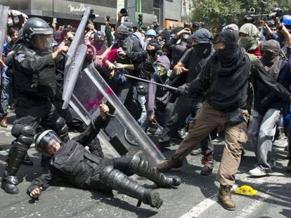 Demonstrators clash with riot police during a protest on September 1, 2013, in Mexico City.