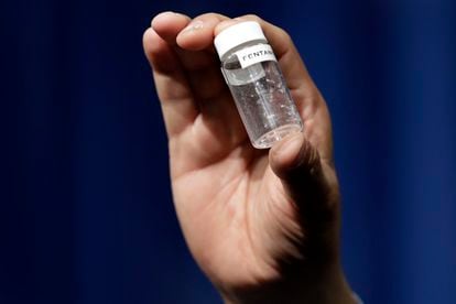 A man holds a vial containing a fatal amount of fentanyl.
