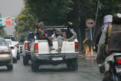 Taliban fighters transport a detainee in Kabul.