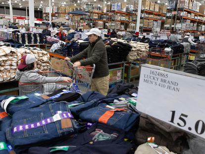 A customer walks past clothing items on sale at a Costco in Washington, DC, USA, February 22, 2024.