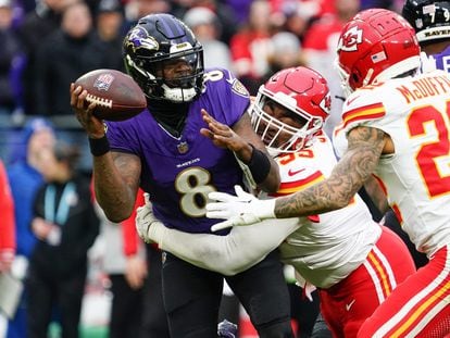 Lamar Jackson (left) is tackled by Chris Jones and Trent McDuffie in the AFC Championship Game.