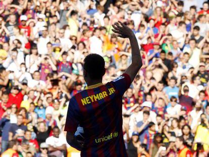 Brazilian striker Neymar waves to Barcelona fans at his presentation at the club.