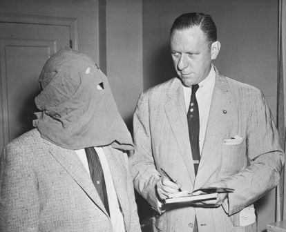 A journalist interviews Igor Gouzenko, who covered his face for fear of reprisals after his defection, in Ottawa in 1945