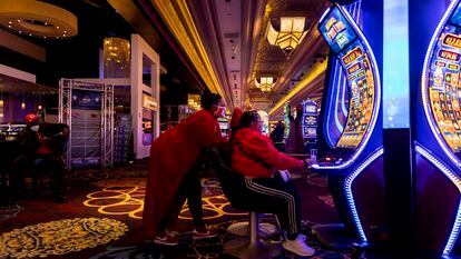 American football supporters play a slot machine in Mandalay Bay Hotel and Casino in Las Vegas, Nevada, USA, 10 February 2024.