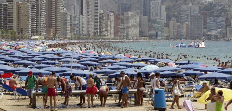 Tourists fill the beach in Benidorm this past summer.