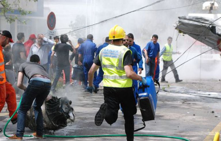 An emergency medic rushes to the scene of the fatal crash on Sunday at the Cuatro Vientos airport in Madrid.