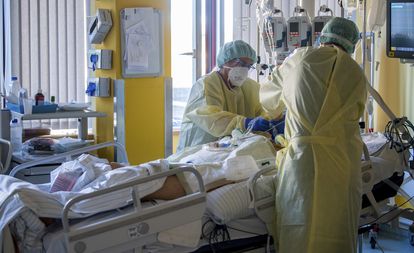 Nurses help a patient in an intensive care unit in Germany.