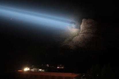 A rescue team helps drones at night by illuminating the site, where the collapse of an ice serac killed six people, in the Marmolada mountain.