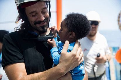A rescue worker with a baby aboard the Aquarius humanitarian ship.