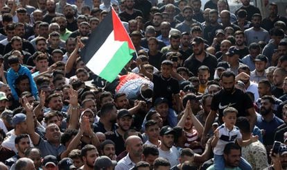 Mohamed, 14, waves a Palestinian flag on Saturday during the burial in As-Sawiya of his father, Bilal Saleh, who was murdered by a Jewish settler while collecting olives.