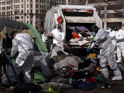 Members of a clean-up crew remove belongings that have been left behind by occupants as the National Park Service clears the homeless encampment at McPherson Square on February 15, 2023 in Washington, DC.