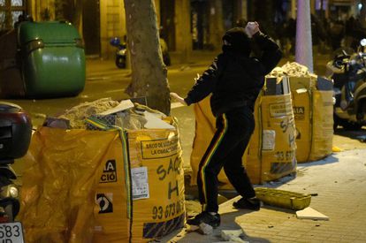 A protester throws a brick at police officers in Barcelona on Thursday.