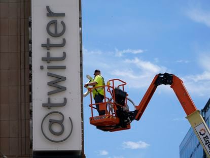 A workman removes a character from a sign on the Twitter headquarters building in San Francisco, Monday, July 24, 2023.