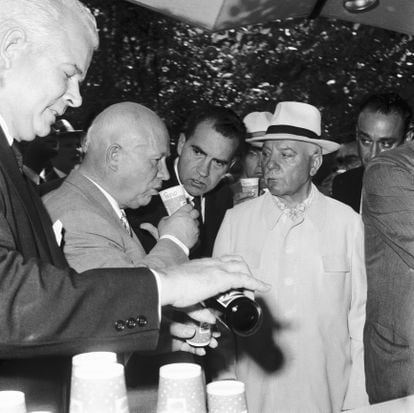 Khrushchev tastes Pepsi-Cola as Nixon watches curiously and Supreme Soviet President Kliment Voroshilov glares in suspicion. 