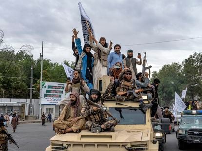 Taliban fighters celebrate one year since they seized the Afghan capital, Kabul, in front of the U.S. Embassy in Kabul, Afghanistan, Monday, Aug. 15, 2022