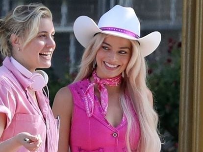 Director Greta Gerwig, with Margot Robbie, both in pink, on the set of 'Barbie.'