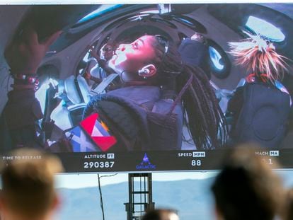Guests watch a live broadcast from inside Virgin Galactic's rocket-powered plane Unity 22, showing space tourists Anastatia Mayers, 18, and her mother Keisha Schahaff, rear, at Spaceport America, near Truth or Consequences, N.M., Thursday, Aug. 10, 2023.