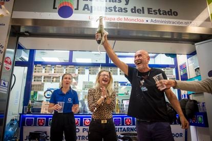 People celebrating outside a lottery sales point in Madrid's Moncloa district.