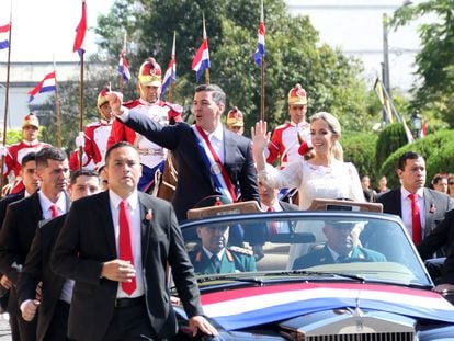 The new president of Paraguay, Santiago Peña, and the first lady, Leticia Ocampos, greet supporters during a car ride after the inauguration ceremony on Aug. 15, 2023.