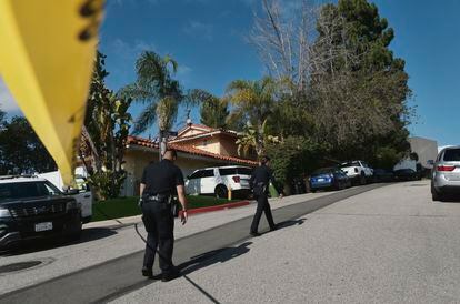 Police block the street to a house where three people were killed and four others wounded in a shooing at a short-term rental home in an upscale Los Angeles neighborhood on Saturday Jan. 28, 2023.