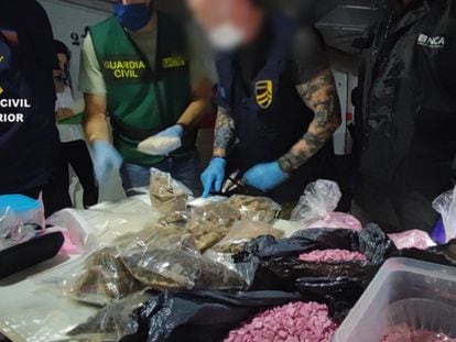 Spanish Civil Guard officers with packets of 'pink cocaine' and other drugs seized in Ibiza.