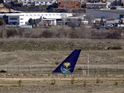 The tail of the Saudi Airlines flight on a runway at Terminal 4.