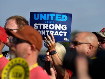 A member holds up a sign at a rally by United Auto Workers Local 863 in Louisville, Ky., on Aug. 24, 2023.
