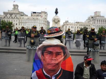 The face of former president Pedro Castillo covers the back of a protester, who is demonstrating against the government of President Dina Boluarte in Lima, on July 19, 2023.