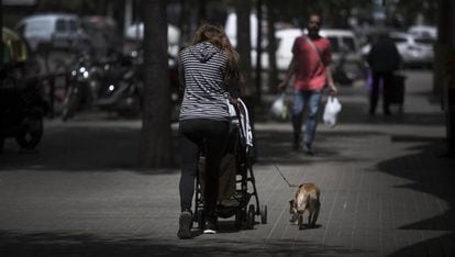 A woman walks her baby in Barcelona.