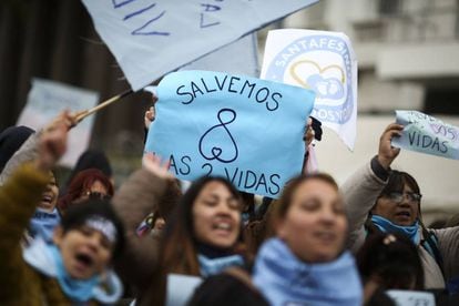 Protest against decriminalization holds a sign reading “Save our two lives”