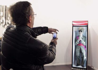 The vicepresident of the Francisco Franco Foundation, Jaime Alonso, takes photos of the offending work at ARCO.