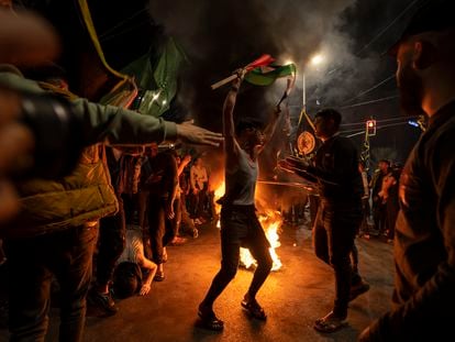 Palestinians celebrate the announcement of a cease-fire after five days of fighting between Israel and the Islamic Jihad militant group in Gaza City, Saturday, May 13, 2023.