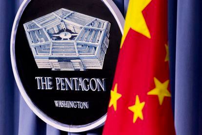 China's national flag is displayed next to the Pentagon logo at the Pentagon, on May 7, 2012.