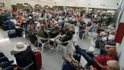 Tourists await their flights in Menorca airport.