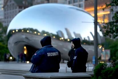 Private security personnel patrol the area around Anish Kapoor's stainless steel sculpture Cloud Gate in Chicago's Millennium Park Thursday