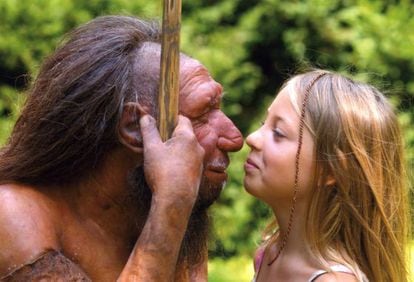 A child peers into the eyes of a model of a Neanderthal man.
