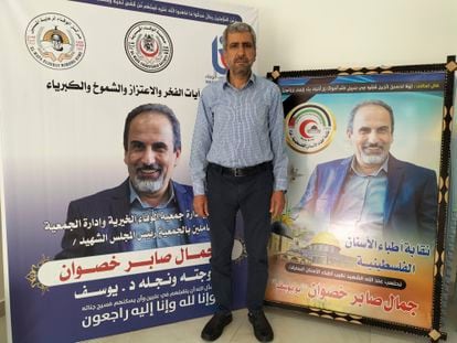 Musa Saber Khaswan stands next to two posters paying tribute to his brother Jamal, one of the victims of Israeli airstrikes against Gaza.