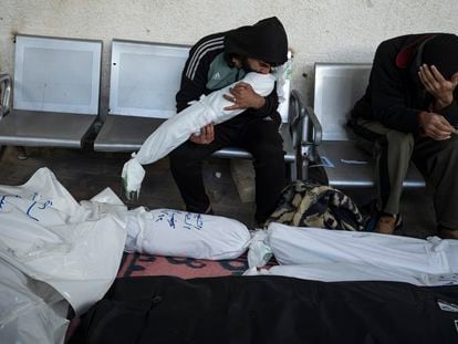 Palestinians mourn relatives killed in the Israeli bombardment of the Gaza Strip in Rafah, Saturday, Jan. 13, 2024.