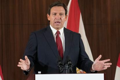 Florida Gov. Ron DeSantis listens to others during a news conference where he spoke of new law enforcement legislation that will be introduced during the upcoming session, Jan. 26, 2023, in Miami.
