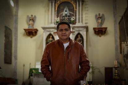 Father Benito Torres in front of the main altar of the parish church.