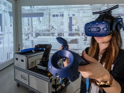 A woman demonstrates the use of Virtual Reality in factory planning