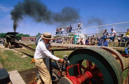 A man tests a steam engine at a festival in the US.