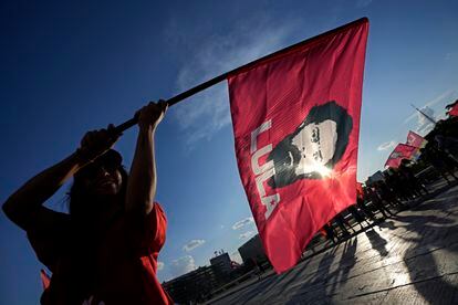 A supporter carries a flag with the image of the Brazil's former president Luiz Inácio Lula da Silva.