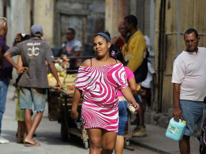 A woman walks in downtown Havana.