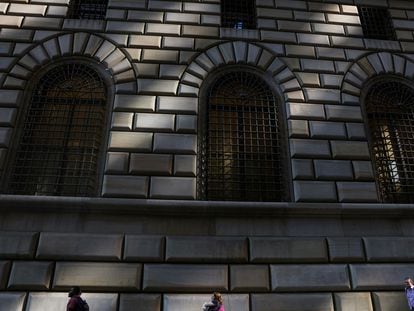 People walk by the Federal Reserve Bank of New York in the financial district of New York City, U.S., June 14, 2023.